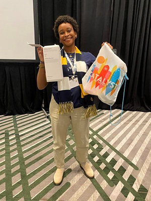 Juliette Seymour receiving a swag bag and a $500 scholarship from PTK