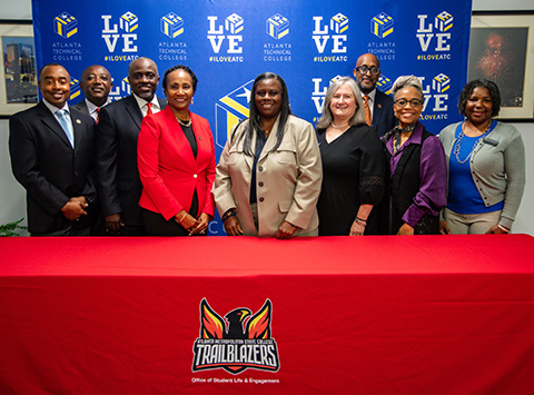 Two representatives from Atlanta Technical College and Atlanta Metropolitan State College signing an articulation agreement